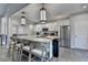Bright, modern kitchen features a central island with seating, stainless steel appliances, and white cabinetry at 3211 Thompson Mill Rd, Buford, GA 30519