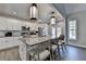 Well-equipped kitchen features an island with seating, stainless steel appliances, and modern lighting at 3211 Thompson Mill Rd, Buford, GA 30519