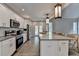 The new kitchen features white cabinetry, stainless steel appliances, and quartz countertops at 3211 Thompson Mill Rd, Buford, GA 30519