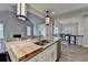 Bright open kitchen features stainless steel appliances, a large island, and is seamlessly connected to the living room at 3211 Thompson Mill Rd, Buford, GA 30519