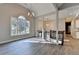 Open-concept living room with hardwood floors, a large window, and a modern chandelier at 3211 Thompson Mill Rd, Buford, GA 30519