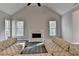 Inviting living room featuring a fireplace, high ceilings, and large windows for ample natural light at 3211 Thompson Mill Rd, Buford, GA 30519