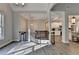Open-concept living room with hardwood floors, a large window, staircase and a modern chandelier at 3211 Thompson Mill Rd, Buford, GA 30519