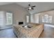 Open-concept living room with fireplace, ceiling fan, hardwood floors, and large windows for natural light at 3211 Thompson Mill Rd, Buford, GA 30519