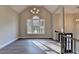 Open-concept living room with hardwood floors, a large window, and a modern chandelier at 3211 Thompson Mill Rd, Buford, GA 30519