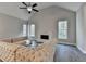 Bright living room boasts high ceilings, a ceiling fan, a fireplace, and large windows with natural light at 3211 Thompson Mill Rd, Buford, GA 30519
