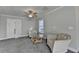 Bedroom sitting area featuring two white chairs, a glass table, and neutral carpeting at 3211 Thompson Mill Rd, Buford, GA 30519