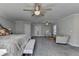 Main bedroom sitting area with stylish chairs, a glass table with a decorative base, and plush carpeting at 3211 Thompson Mill Rd, Buford, GA 30519