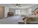 Main bedroom features a crib, a large bed, a bench seat, and a large window at 3211 Thompson Mill Rd, Buford, GA 30519