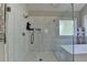 Bright bathroom featuring an elegant glass shower with white tile surround and a separate soaking tub at 3211 Thompson Mill Rd, Buford, GA 30519