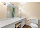 Bathroom features vanity with round mirror, neutral walls, and seat at vanity at 5400 Roswell Rd # J2, Atlanta, GA 30342
