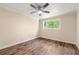Bedroom features wood-look floors, neutral walls, and a window with green views at 5400 Roswell Rd # J2, Atlanta, GA 30342
