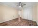 Bedroom featuring hardwood floors, fan light, and closet with white doors at 5400 Roswell Rd # J2, Atlanta, GA 30342