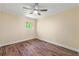 Bedroom features wood-look floors, neutral walls, and a window with exterior views at 5400 Roswell Rd # J2, Atlanta, GA 30342