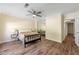 Neutral bedroom featuring wood flooring, a ceiling fan, large windows, and mirrored closet doors at 5400 Roswell Rd # J2, Atlanta, GA 30342