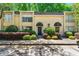 Charming townhome featuring a manicured front yard and a classic brick facade with black awnings above the entries at 5400 Roswell Rd # J2, Atlanta, GA 30342