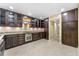 Spacious kitchen featuring dark wood cabinetry, granite countertops, stainless steel appliances and tile flooring at 5400 Roswell Rd # J2, Atlanta, GA 30342