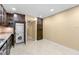 Bright kitchen featuring stainless steel appliances, granite countertops, washer and dryer, and dark wood cabinetry at 5400 Roswell Rd # J2, Atlanta, GA 30342