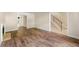 Inviting living room with wood-look flooring, a classic fireplace, and an entryway leading to the elegant foyer staircase at 5400 Roswell Rd # J2, Atlanta, GA 30342