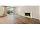 Comfortable living room with wood-look flooring, a charming fireplace, and a bright window with elegant draperies at 5400 Roswell Rd # J2, Atlanta, GA 30342