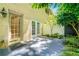Outdoor patio features greenery, natural light, brick walls, and glass doors at 5400 Roswell Rd # J2, Atlanta, GA 30342