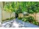 Outdoor patio featuring trees, greenery, and a brick wall at 5400 Roswell Rd # J2, Atlanta, GA 30342