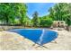 Community pool with secure cover in a landscaped setting and residential buildings in the background at 5400 Roswell Rd # J2, Atlanta, GA 30342