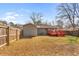 Fenced backyard with lawn and red deck, offering privacy and outdoor living space at 1021 Magnolia Se Dr, Smyrna, GA 30082