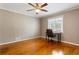 Neutral bedroom with hardwood floors and a ceiling fan, providing a comfortable living space at 1021 Magnolia Se Dr, Smyrna, GA 30082