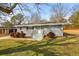 Charming one-story home with grey painted brick, landscaped yard and a welcoming front entrance at 1021 Magnolia Se Dr, Smyrna, GA 30082