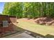 Lush green backyard with a private fence, patio, and mature trees at 1983 Silver Birch Se Dr, Smyrna, GA 30080
