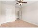 Bedroom showcasing neutral carpet, a ceiling fan, and two white doors with hardware at 1983 Silver Birch Se Dr, Smyrna, GA 30080