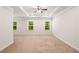 Bright bedroom with carpet, tray ceiling, and windows providing natural light at 1983 Silver Birch Se Dr, Smyrna, GA 30080