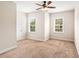 Bedroom featuring neutral walls, carpet, two windows, and a ceiling fan at 1983 Silver Birch Se Dr, Smyrna, GA 30080