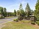 Welcoming entrance to The Terrace featuring stone signage surrounded by vibrant flowers and manicured landscaping at 1983 Silver Birch Se Dr, Smyrna, GA 30080