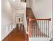 Foyer with hardwood floors, staircase with decorative metal railing, and view into other rooms at 1983 Silver Birch Se Dr, Smyrna, GA 30080