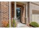 A close up view of the front entry way with a gray front door, a stone base, and the house number at 1983 Silver Birch Se Dr, Smyrna, GA 30080