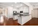 Open kitchen features granite countertops, stainless appliances, and seamless flow to living area at 1983 Silver Birch Se Dr, Smyrna, GA 30080