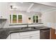 Bright kitchen featuring granite counters, white cabinetry, stainless steel dishwasher, and backyard view at 1983 Silver Birch Se Dr, Smyrna, GA 30080