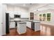 A bright kitchen featuring white cabinets, stainless steel appliances, granite countertops, and hardwood floors at 1983 Silver Birch Se Dr, Smyrna, GA 30080