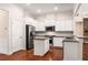 A bright, open kitchen featuring white cabinets, stainless steel appliances, and granite countertops at 1983 Silver Birch Se Dr, Smyrna, GA 30080