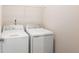 Laundry room featuring white appliances, wire shelving, and light walls at 1983 Silver Birch Se Dr, Smyrna, GA 30080