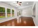 Spacious living area featuring hardwood floors, decorative molding, backyard view, and kitchen access at 1983 Silver Birch Se Dr, Smyrna, GA 30080