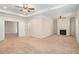 Spacious main bedroom featuring a fireplace, tray ceiling, and carpeted floor at 1983 Silver Birch Se Dr, Smyrna, GA 30080