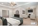 Staged main bedroom featuring a fireplace, tray ceiling, and sitting area at 1983 Silver Birch Se Dr, Smyrna, GA 30080