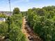 Scenic view of the road construction between lush green trees and nearby buildings under a bright sky at 1983 Silver Birch Se Dr, Smyrna, GA 30080