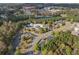 Aerial view of the community clubhouse and pool area nestled among trees, and a scenic lake nearby at 307 Jessica Way, Canton, GA 30114