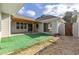 View of private backyard with artificial grass, rock garden, wood fence, and covered patio at 307 Jessica Way, Canton, GA 30114