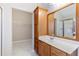 Bathroom features a vanity with a mirror and a walk-in closet with wire shelves at 307 Jessica Way, Canton, GA 30114
