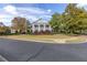 Pillar-fronted clubhouse exuding classic charm, complemented by manicured landscaping and mature trees on a sunny day at 307 Jessica Way, Canton, GA 30114